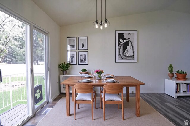 dining room featuring vaulted ceiling, healthy amount of natural light, and baseboards