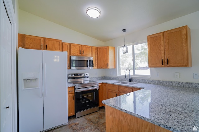 kitchen featuring appliances with stainless steel finishes, vaulted ceiling, a sink, pendant lighting, and light stone countertops