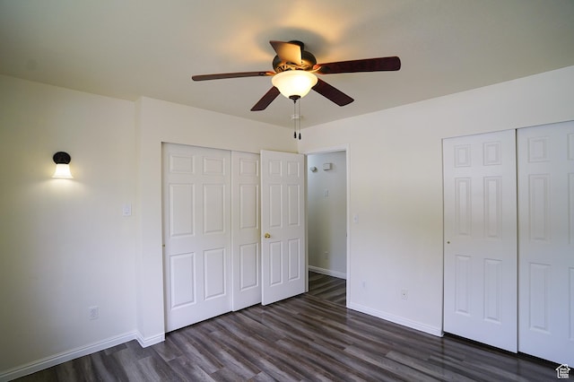 unfurnished bedroom featuring dark wood finished floors, baseboards, and a ceiling fan
