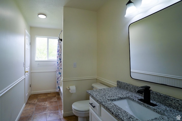 full bathroom featuring toilet, vanity, baseboards, and shower / bath combination with curtain