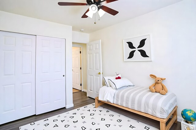 bedroom with wood finished floors, a closet, baseboards, and ceiling fan