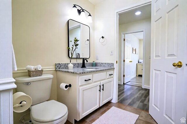 bathroom with vanity, toilet, and tile patterned flooring