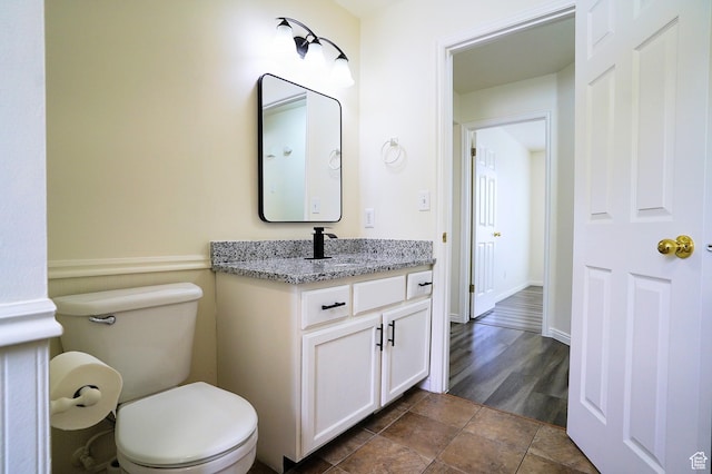 bathroom featuring toilet and vanity