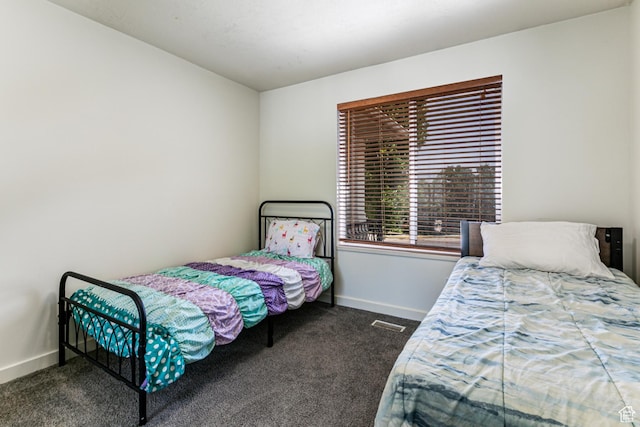 bedroom featuring baseboards, carpet flooring, and visible vents