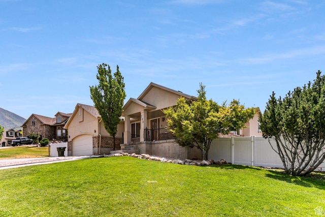 ranch-style house with fence, a porch, a front yard, and stucco siding