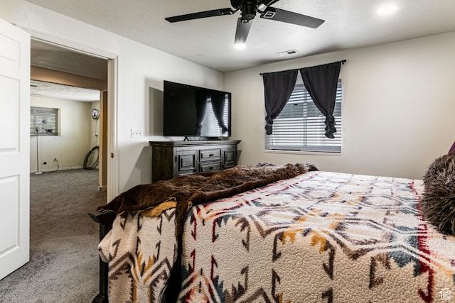 bedroom with carpet, visible vents, and ceiling fan