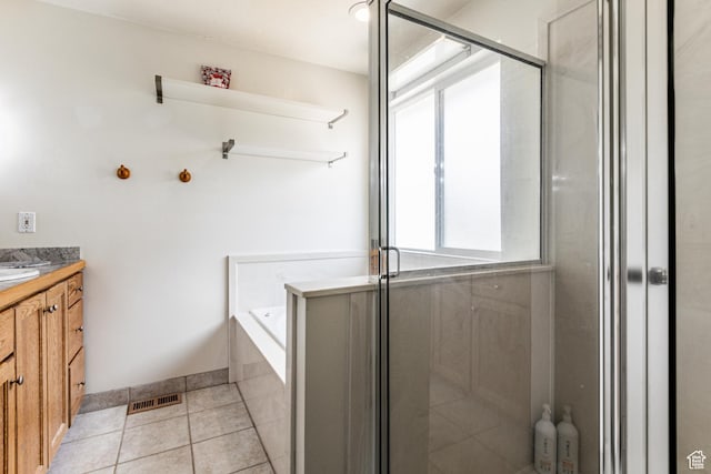 bathroom with a shower stall, a garden tub, vanity, tile patterned flooring, and visible vents