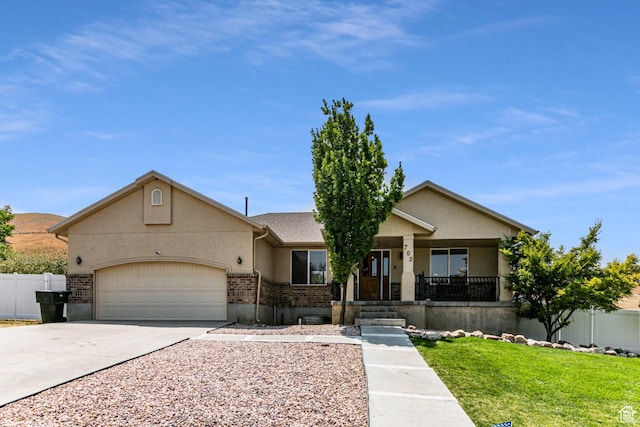 ranch-style house with fence, concrete driveway, an attached garage, stucco siding, and covered porch