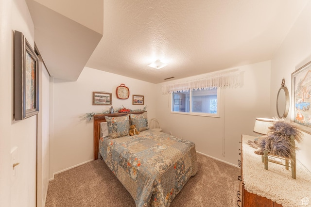 bedroom featuring baseboards, a textured ceiling, and light colored carpet