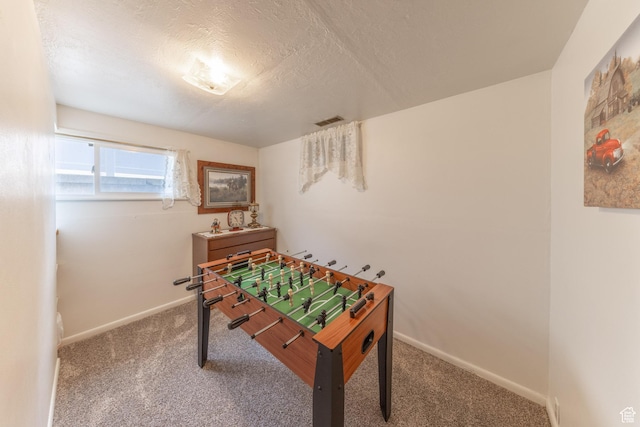 rec room with baseboards, visible vents, carpet floors, and a textured ceiling