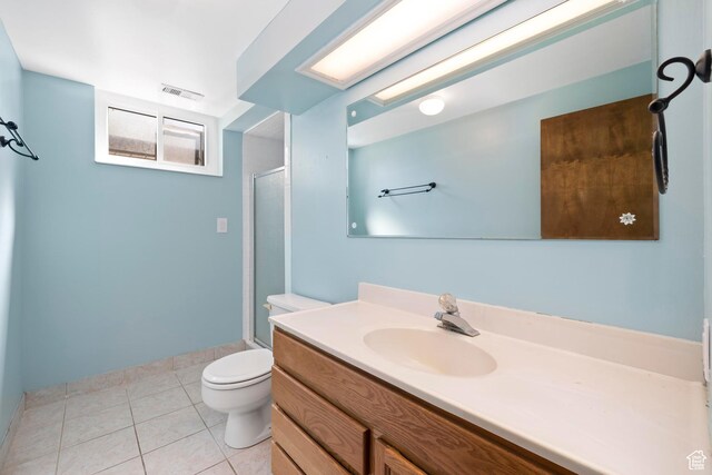 bathroom with toilet, visible vents, tile patterned flooring, a shower stall, and vanity