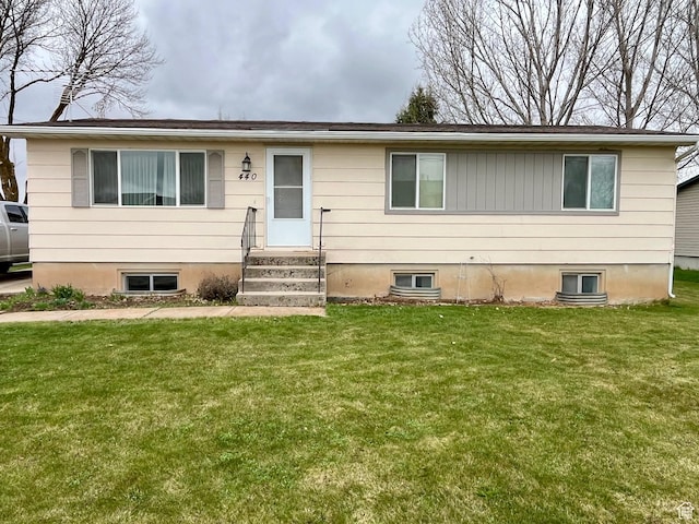 ranch-style home featuring entry steps and a front yard