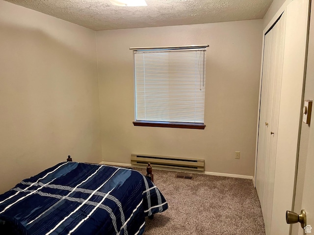 440 S 400 W, Preston, ID 83263 - bedroom with a closet, carpet, a textured ceiling, and baseboard heating