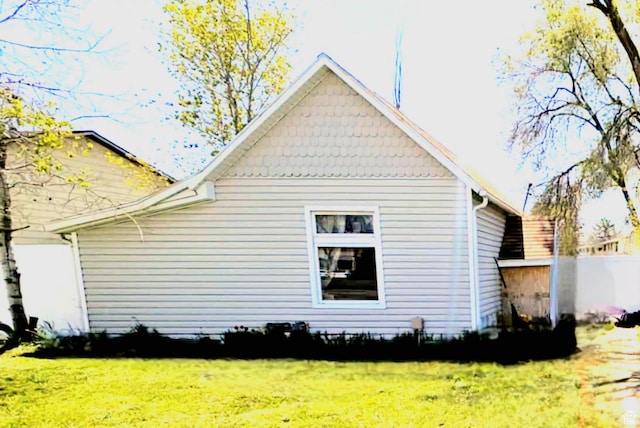 view of side of home featuring a lawn