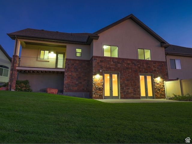 851 E Oak Ct Unit 28, Tooele, UT 84074 - view of front of home featuring stucco siding, stone siding, a front yard, and french doors
