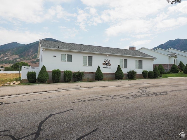 851 E Oak Ct Unit 28, Tooele, UT 84074 - single story home with fence, a chimney, a mountain view, and stucco siding