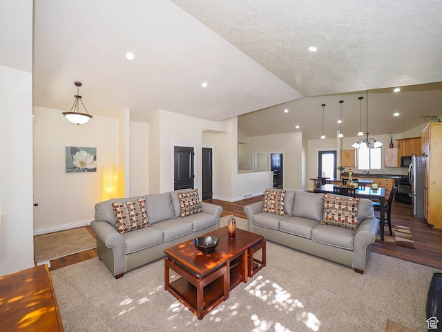 851 E Oak Ct Unit 28, Tooele, UT 84074 - living room featuring recessed lighting, vaulted ceiling, wood finished floors, and baseboards