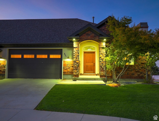 851 E Oak Ct Unit 28, Tooele, UT 84074 - view of front of house with an attached garage, driveway, stone siding, and a front yard