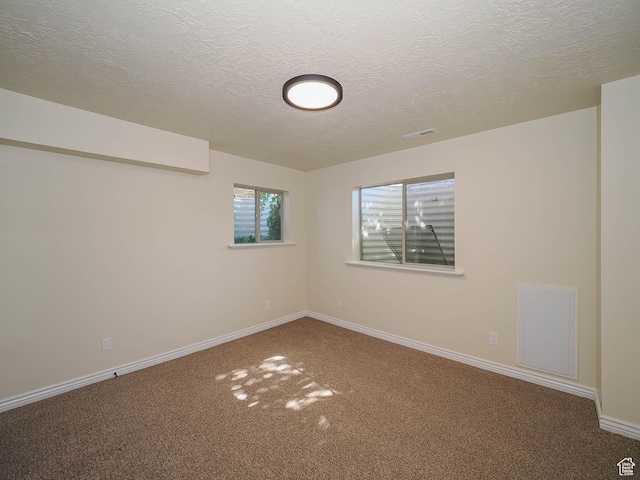 851 E Oak Ct Unit 28, Tooele, UT 84074 - carpeted spare room with a textured ceiling, baseboards, and visible vents