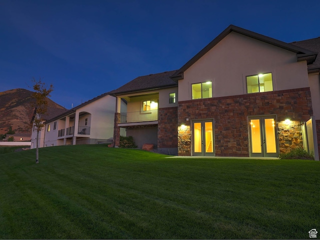 851 E Oak Ct Unit 28, Tooele, UT 84074 - back of house with stucco siding, a yard, stone siding, and french doors