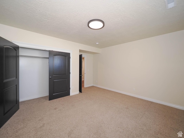 851 E Oak Ct Unit 28, Tooele, UT 84074 - unfurnished bedroom with light carpet, baseboards, a textured ceiling, and a closet