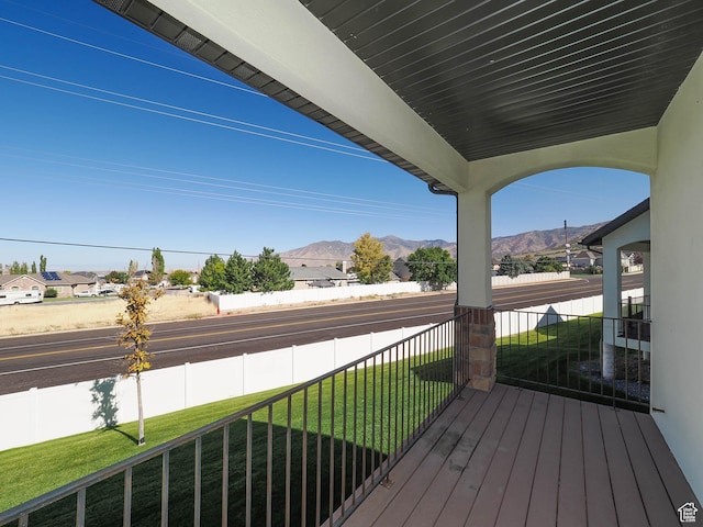 851 E Oak Ct Unit 28, Tooele, UT 84074 - wooden terrace featuring fence, a porch, a yard, and a mountain view