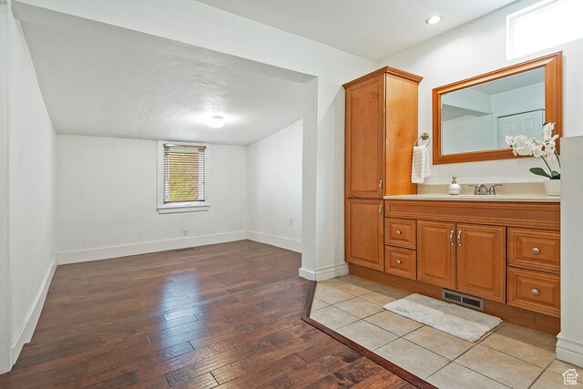 731 E Roosevelt Ave, Salt Lake City, UT 84105 - bathroom with wood-type flooring, visible vents, vanity, and baseboards