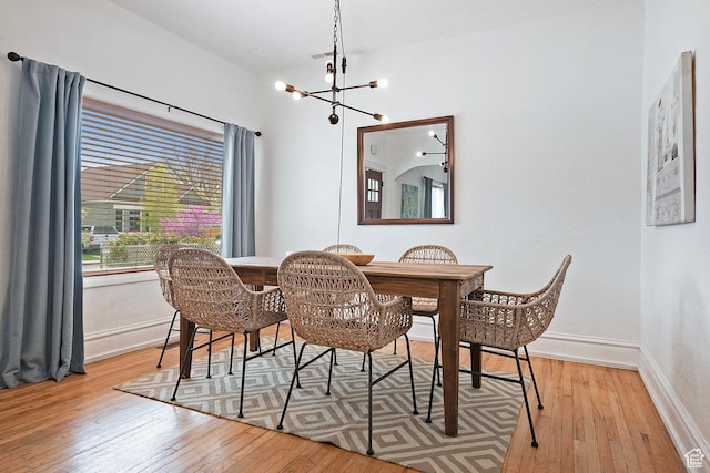 731 E Roosevelt Ave, Salt Lake City, UT 84105 - dining space featuring baseboards, a notable chandelier, visible vents, and light wood-type flooring