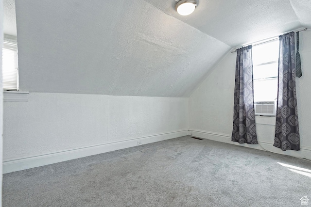 731 E Roosevelt Ave, Salt Lake City, UT 84105 - additional living space with vaulted ceiling, a textured ceiling, a textured wall, carpet, and baseboards