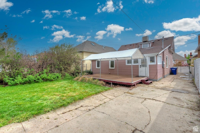 731 E Roosevelt Ave, Salt Lake City, UT 84105 - back of house with a lawn, a chimney, fence, and a deck