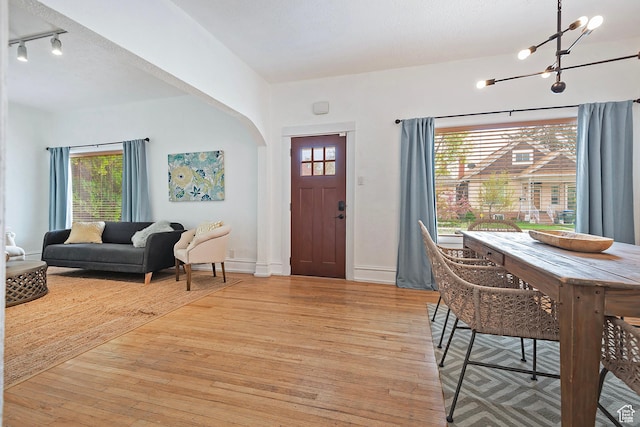 731 E Roosevelt Ave, Salt Lake City, UT 84105 - entrance foyer featuring arched walkways, light wood-style flooring, baseboards, and an inviting chandelier