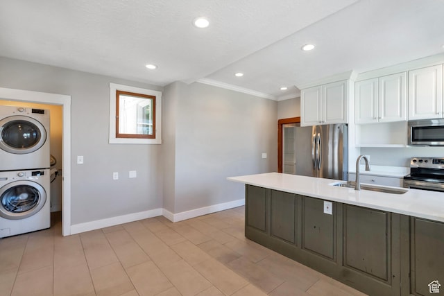 480 N 300 W, Salt Lake City, UT 84103 - kitchen featuring a sink, stacked washing maching and dryer, stainless steel appliances, light countertops, and baseboards