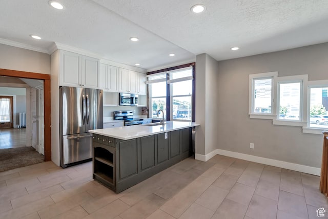 480 N 300 W, Salt Lake City, UT 84103 - kitchen with radiator heating unit, stainless steel appliances, white cabinets, and a wealth of natural light