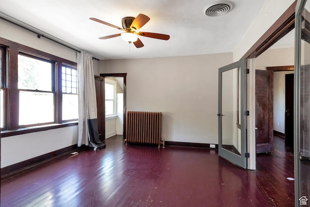 480 N 300 W, Salt Lake City, UT 84103 - empty room featuring hardwood / wood-style flooring, a ceiling fan, radiator heating unit, and visible vents
