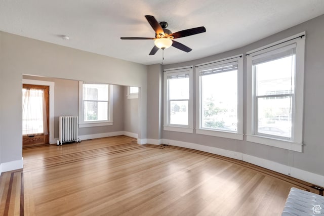 480 N 300 W, Salt Lake City, UT 84103 - unfurnished room featuring radiator, light wood finished floors, baseboards, and ceiling fan