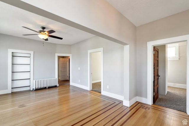 480 N 300 W, Salt Lake City, UT 84103 - unfurnished room with radiator heating unit, light wood-type flooring, baseboards, built in shelves, and ceiling fan