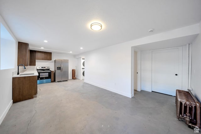 480 N 300 W, Salt Lake City, UT 84103 - unfurnished living room with baseboards, concrete flooring, a sink, and stacked washing maching and dryer