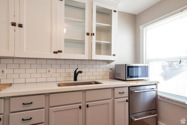 480 N 300 W, Salt Lake City, UT 84103 - kitchen with a sink, stainless steel microwave, glass insert cabinets, a wealth of natural light, and tasteful backsplash