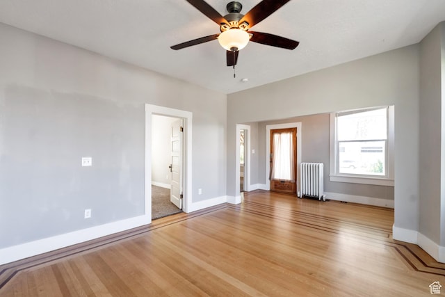 480 N 300 W, Salt Lake City, UT 84103 - unfurnished bedroom featuring radiator, light wood-style floors, baseboards, and ceiling fan