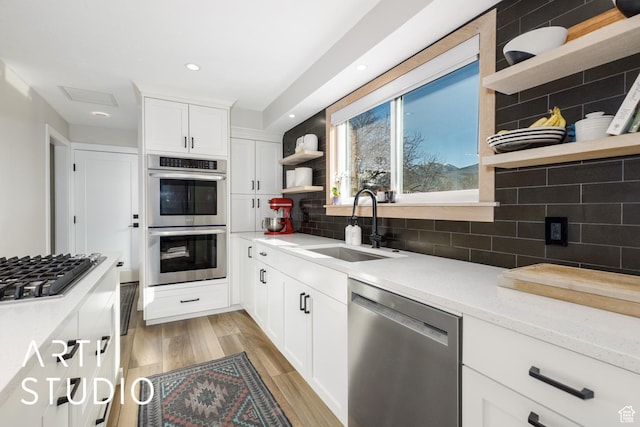 3116 N River Dr E, Eden, UT 84310 - kitchen featuring open shelves, tasteful backsplash, stainless steel appliances, and a sink