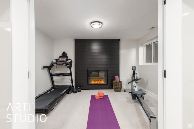 3116 N River Dr E, Eden, UT 84310 - workout room with visible vents, a large fireplace, and a textured ceiling