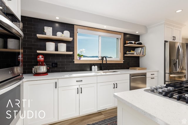 3116 N River Dr E, Eden, UT 84310 - kitchen featuring open shelves, tasteful backsplash, stainless steel appliances, and a sink