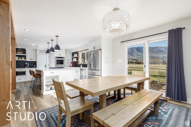 3116 N River Dr E, Eden, UT 84310 - dining space featuring light wood-style flooring, recessed lighting, a notable chandelier, and a mountain view