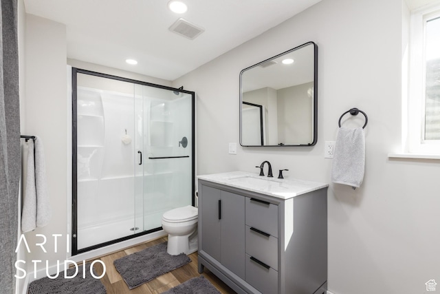 3116 N River Dr E, Eden, UT 84310 - full bathroom with wood finished floors, a stall shower, vanity, toilet, and visible vents