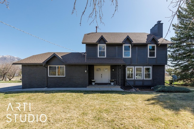 3116 N River Dr E, Eden, UT 84310 - traditional home featuring a chimney, brick siding, a front yard, and roof with shingles