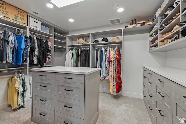 walk in closet with visible vents and light colored carpet