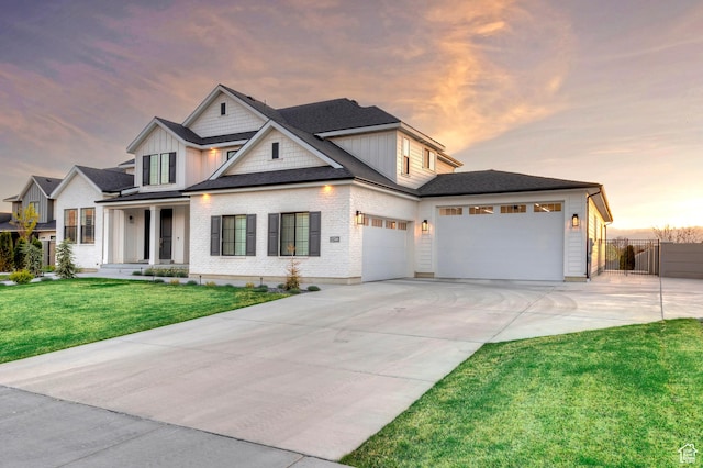 view of front facade featuring concrete driveway, a front lawn, board and batten siding, an attached garage, and fence