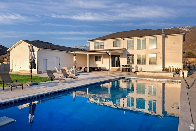 back of house featuring an outdoor pool, a patio, and fence