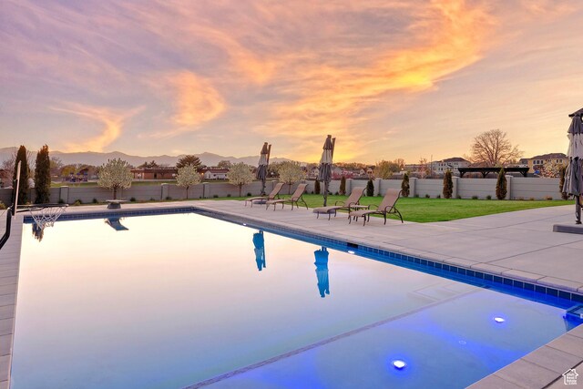 view of pool with a patio area, a fenced in pool, fence, and a lawn
