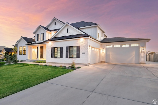 modern farmhouse with a lawn, driveway, board and batten siding, and a garage